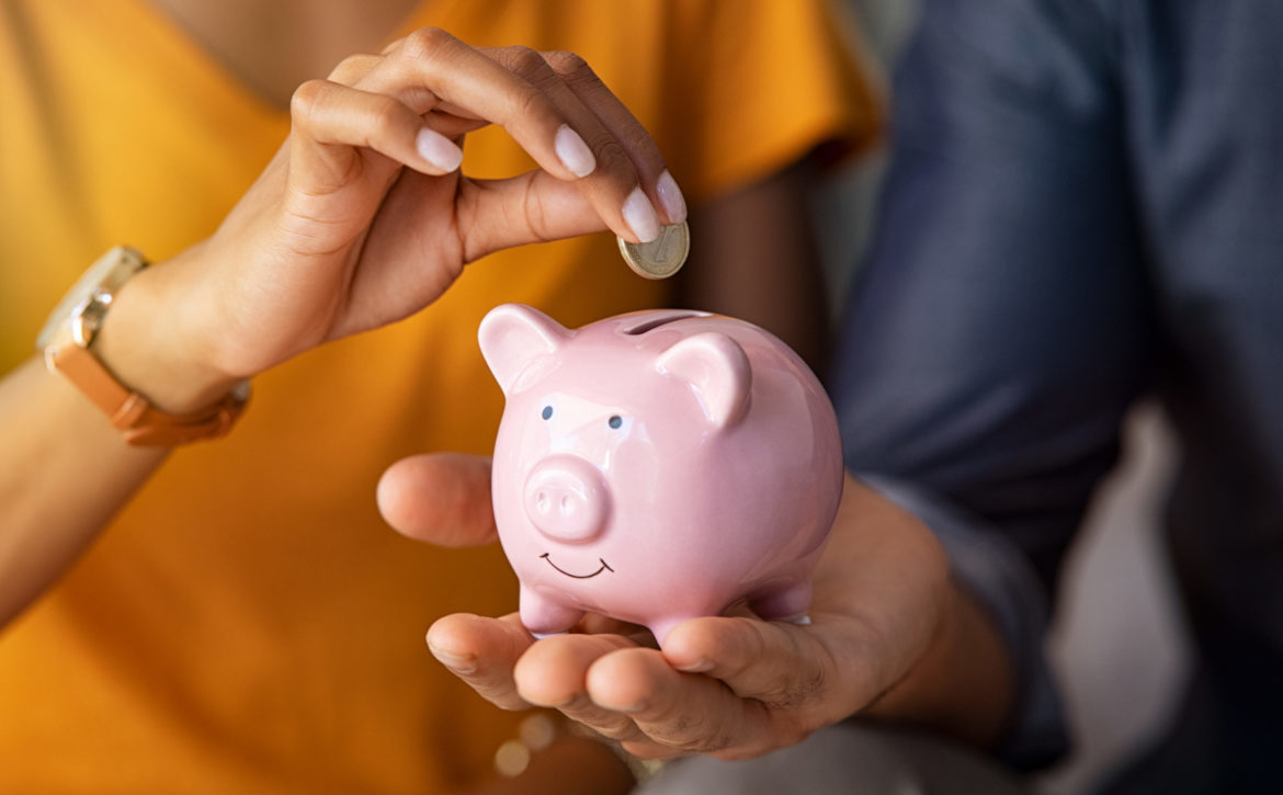 Couple saving money in piggybank